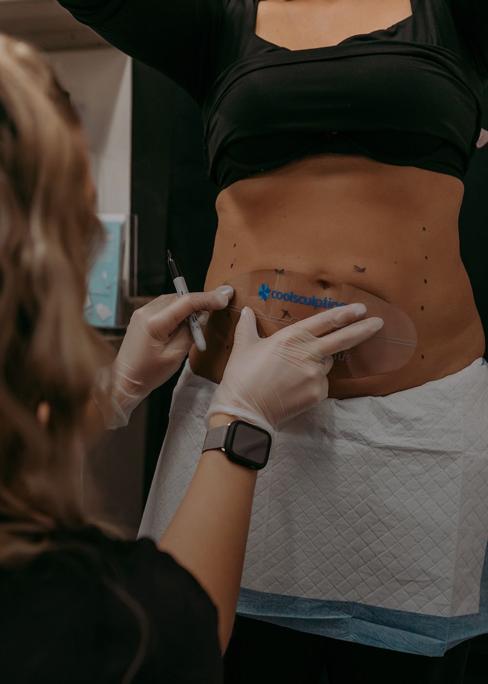 Woman in activewear seated on outdoor steps.