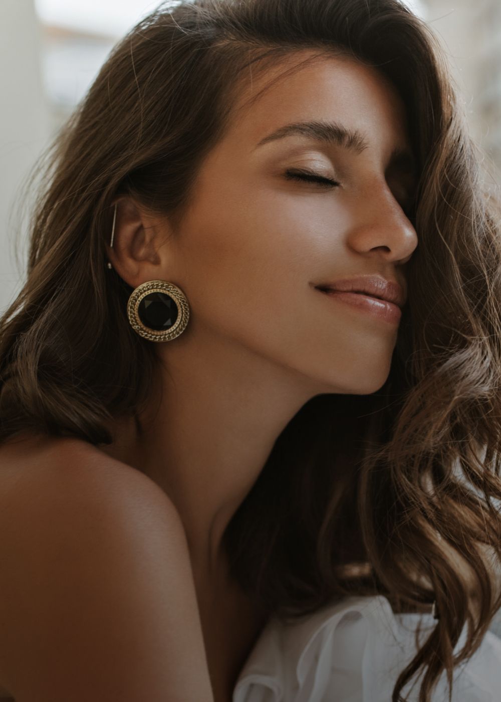 Woman in activewear sitting on stairs.
