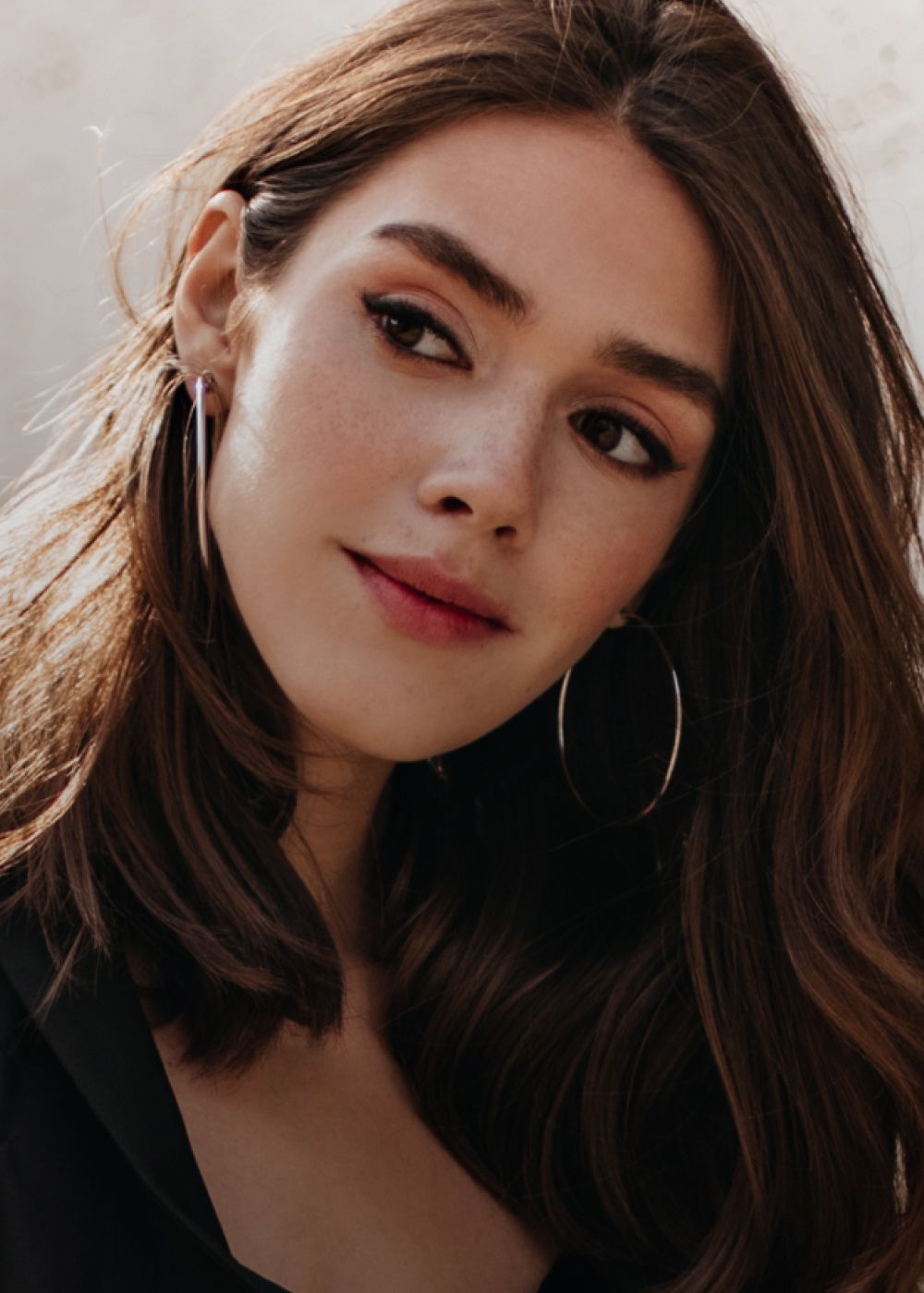 Woman in activewear sitting on stairs.