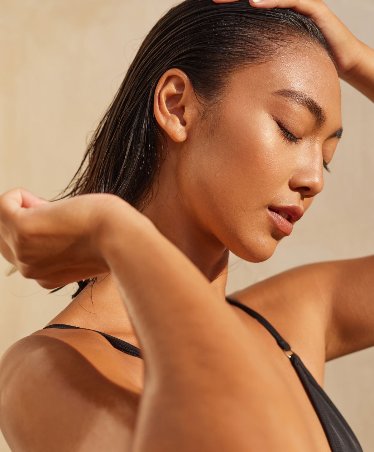 Model with sleek hair and relaxed expression.