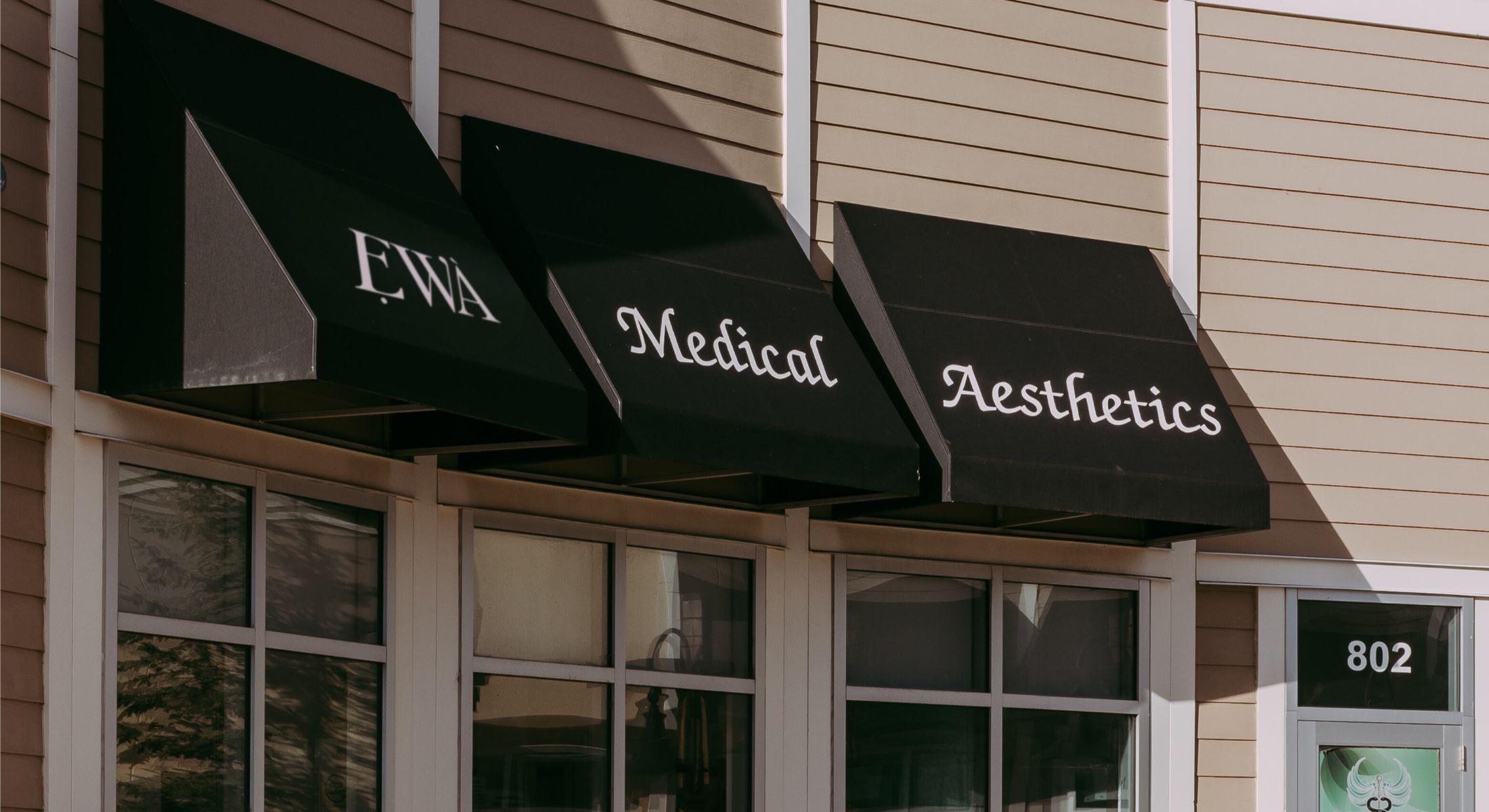 EWA Medical Aesthetics storefront with black awnings.