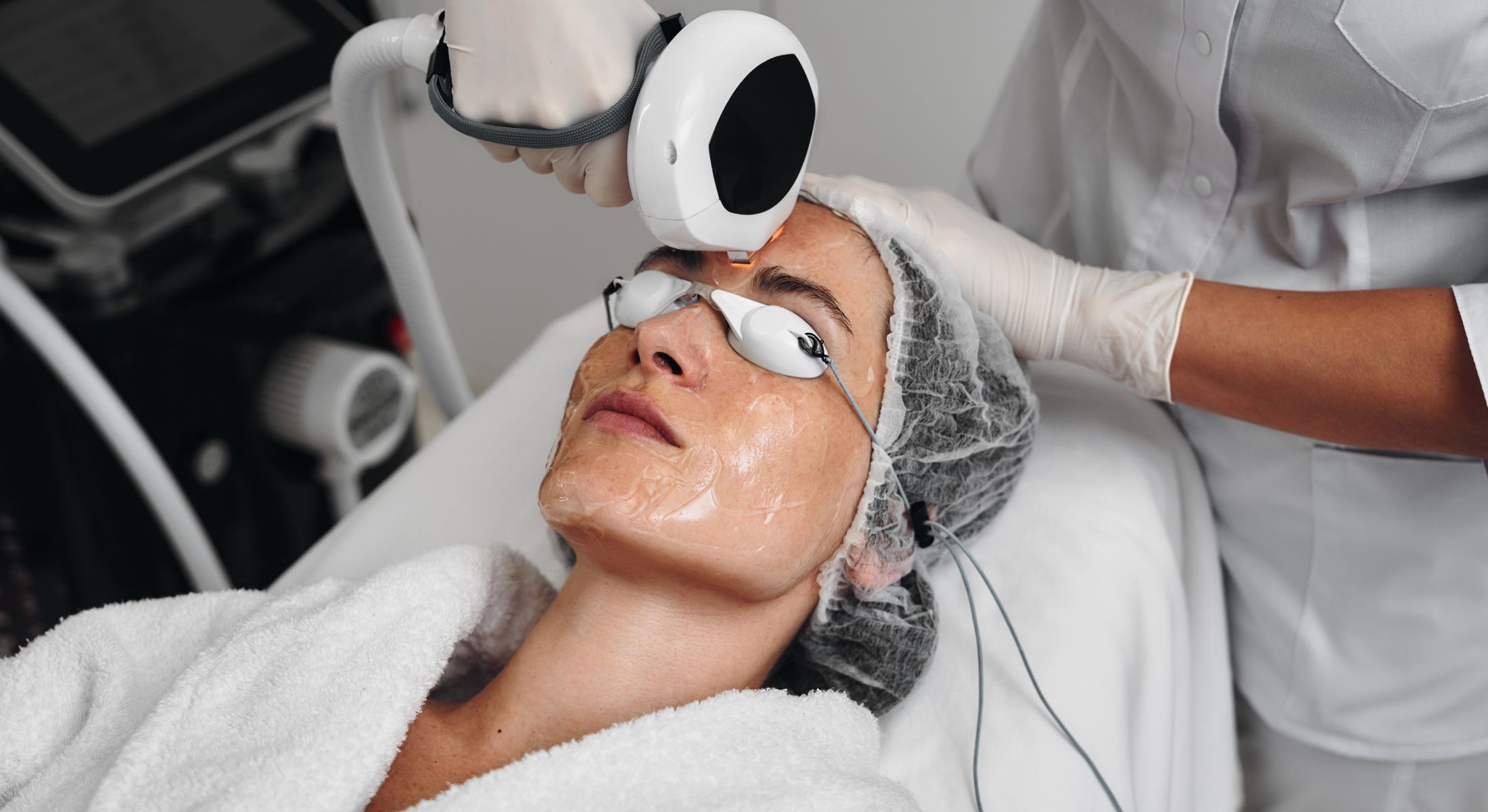Woman receiving a facial laser treatment.